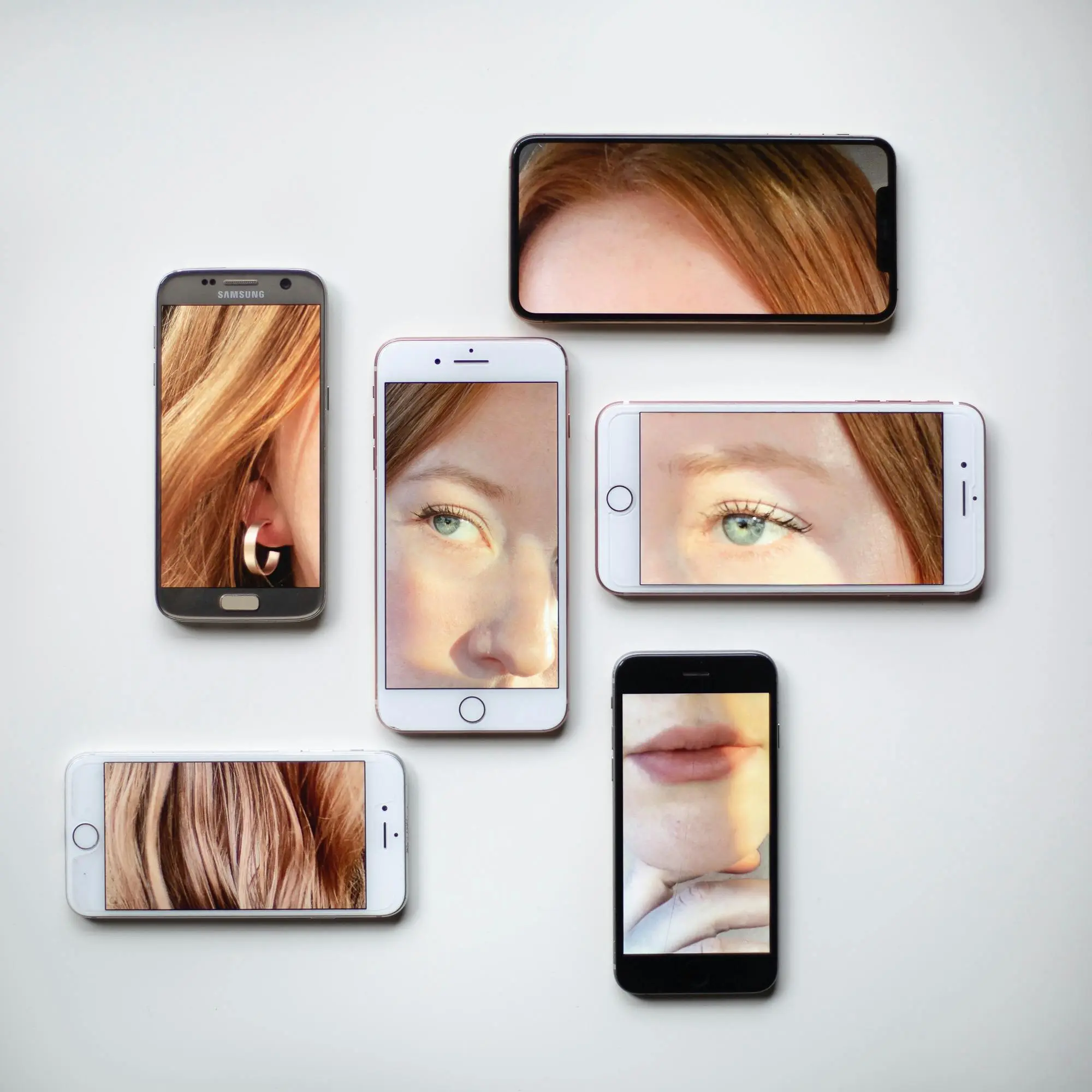 Woman's face on multiple smartphones